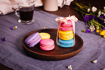 Colorful Macarons Gift Box With Coffee And Flowers On Table