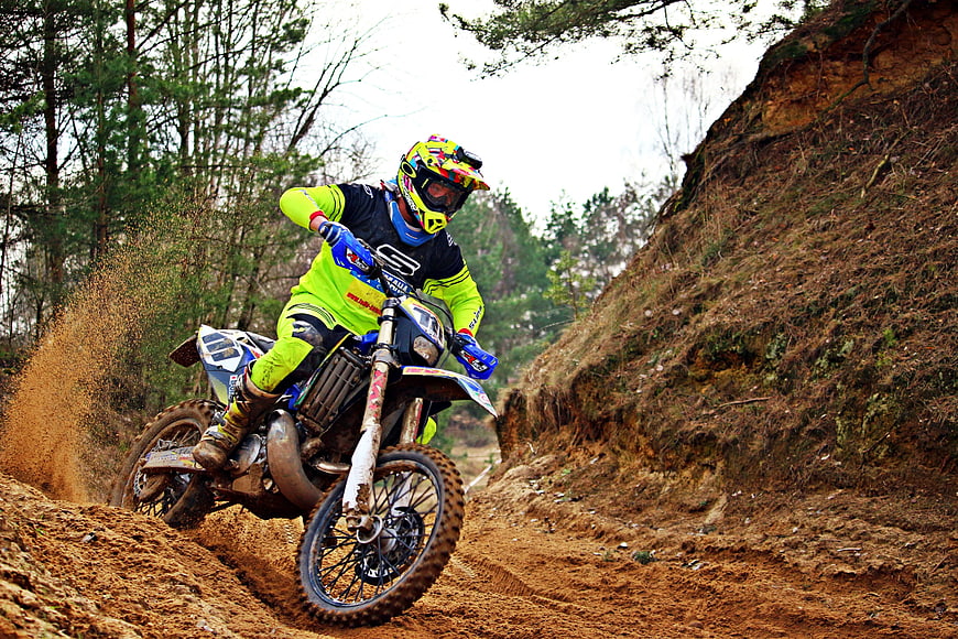 Motocross Rider Cornering on Dirt Track
