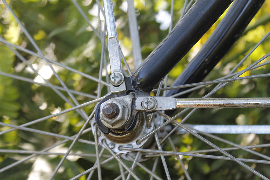 Close-up of vintage bicycle wheel hub and spokes outdoors
