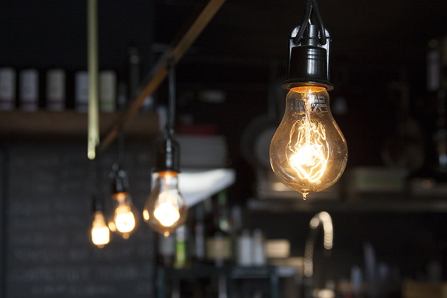 Vintage Edison Light Bulbs Hanging In Dark Industrial Interior