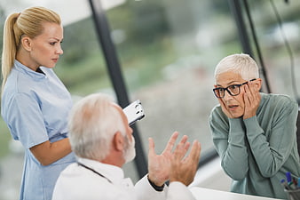 Senior Woman Shocked by Doctor Diagnosis with Nurse