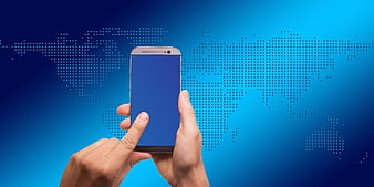 Hand holding smartphone with world map background