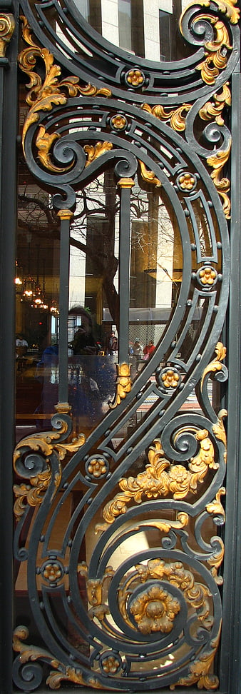 Ornate black and gold wrought iron gate detail
