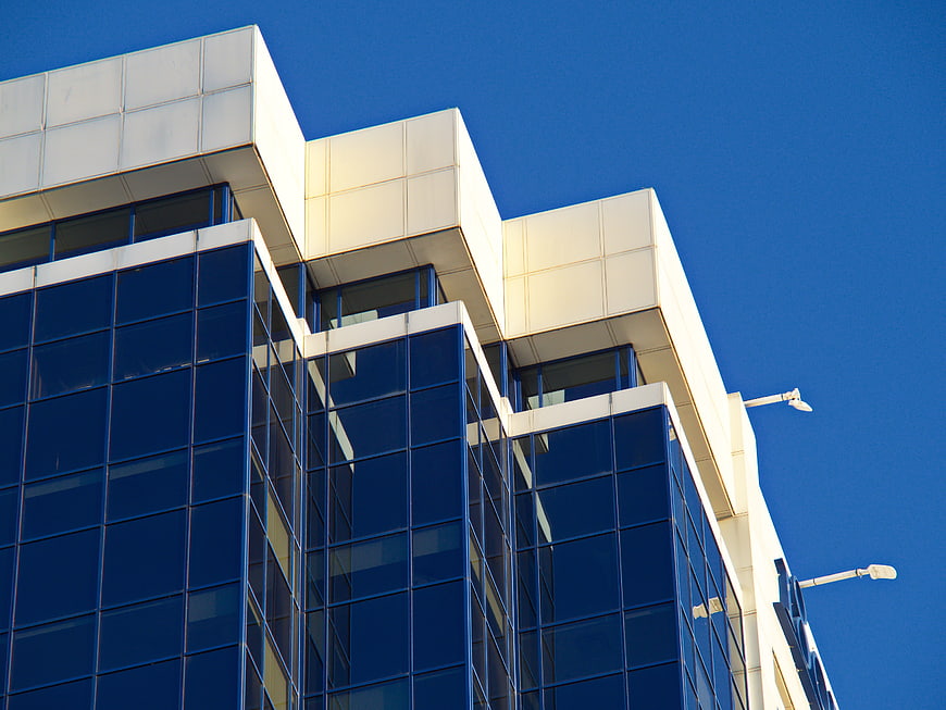 Modern Glass Office Building Architecture Against Blue Sky