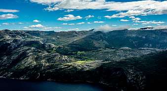 Aerial View of Dramatic Mountain Landscape with Fjord and Blue Sky