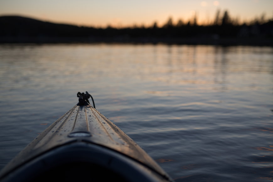 Kayak Bow on Calm Water at Sunset