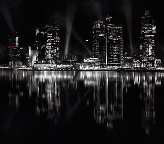 Black and white night cityscape with water reflections