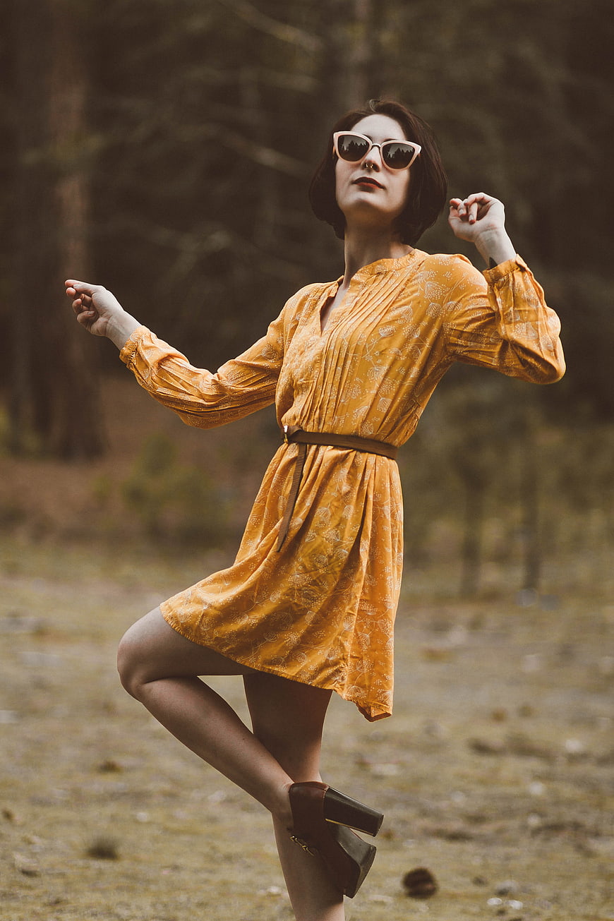 Woman in Yellow Dress Dancing in Forest