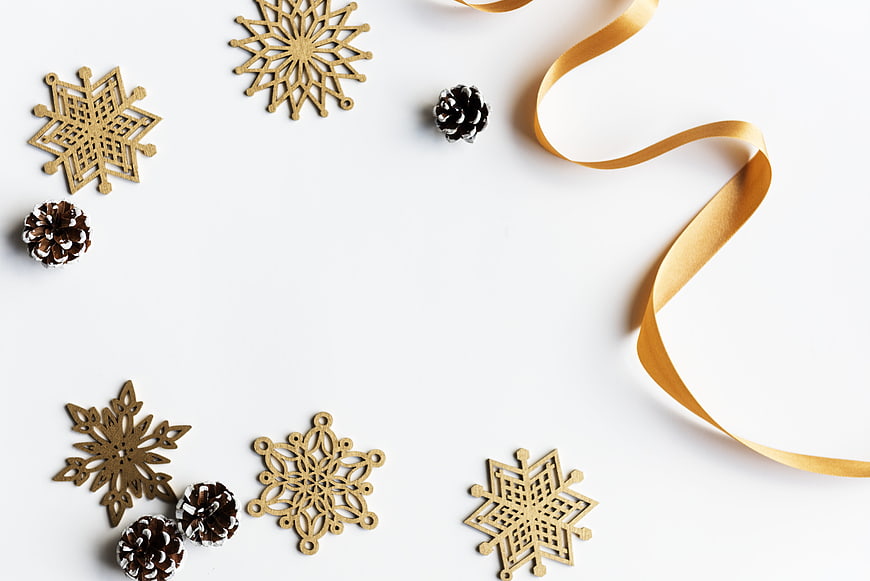 Minimalist Christmas Flat Lay with Gold Snowflakes and Ribbon