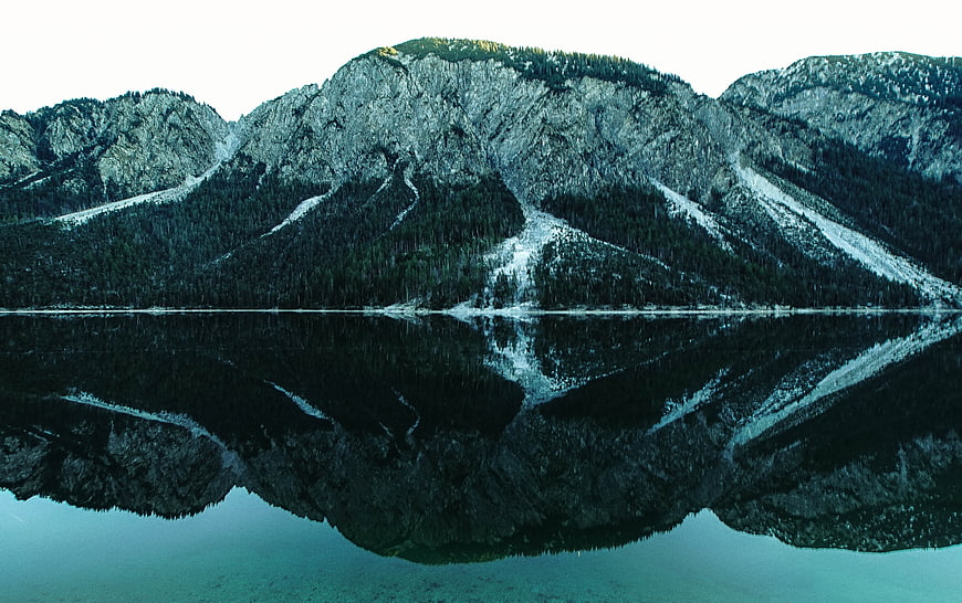 Serene Mountain Lake Reflection with Snowy Peaks