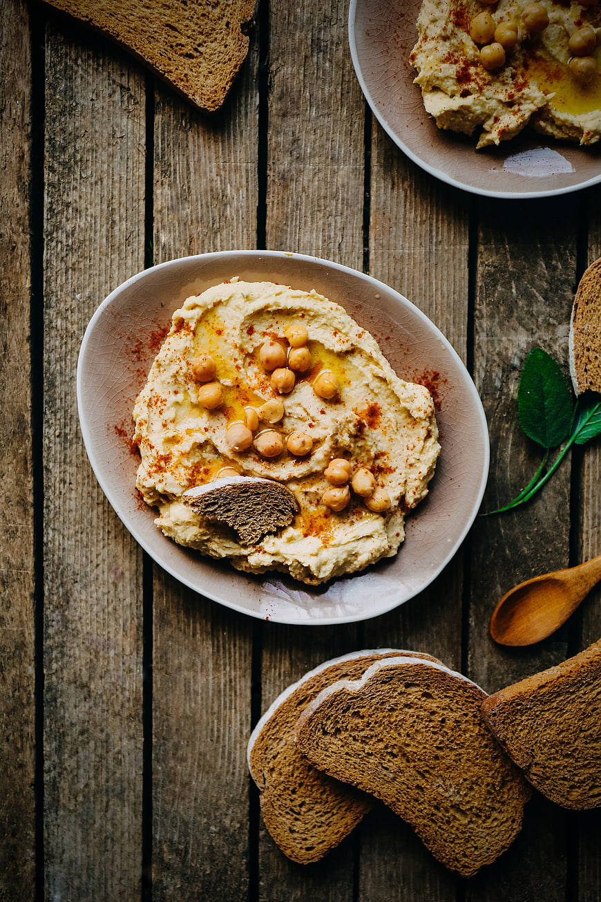 Top View of Creamy Hummus with Chickpeas and Whole Wheat Bread