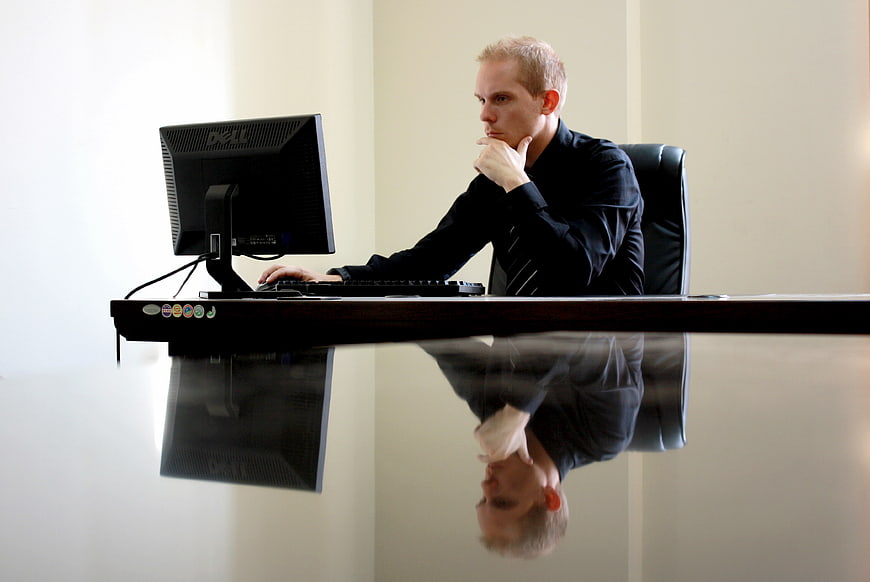 Thoughtful Businessman Working at Office Desk