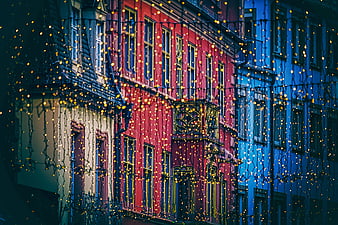 Colorful European Townhouses With Christmas Fairy Lights At Night