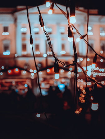 Festive Christmas Lights Hanging at Night with Bokeh Background