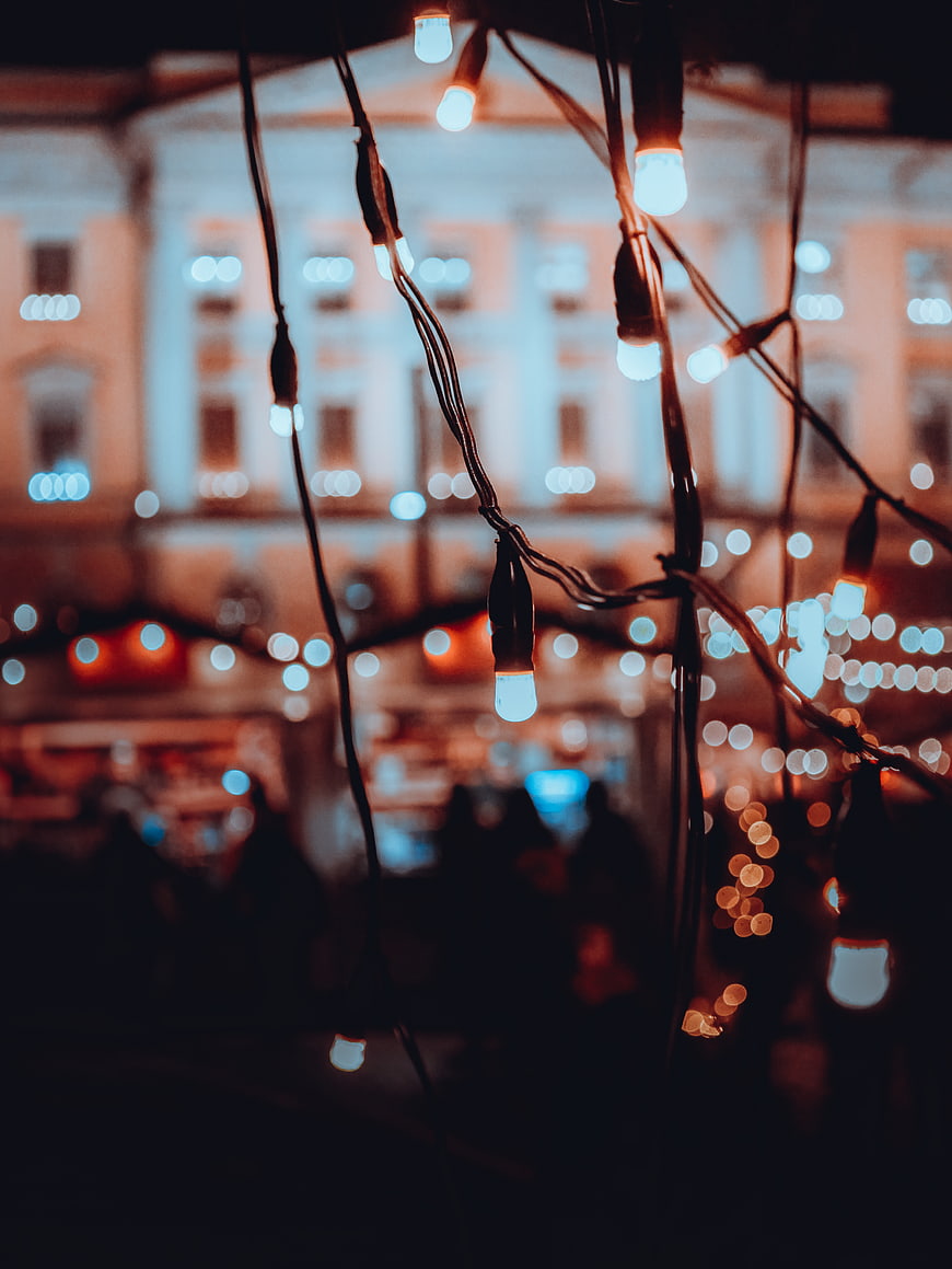 Festive Christmas Lights Hanging at Night with Bokeh Background