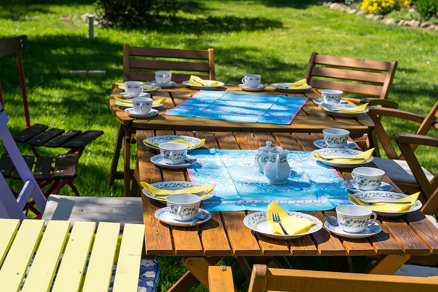 Outdoor Garden Tea Party Setup With Blue Tablecloth