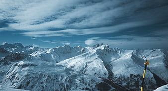Snowy Mountain Landscape with Warning Sign and Cloudy Sky