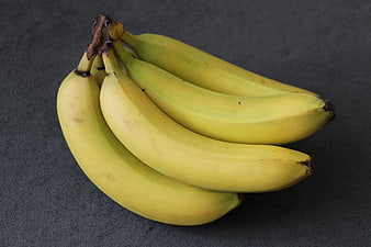 Bunch of Ripe Yellow Bananas on Dark Gray Textured Surface