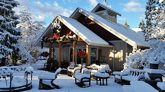 Snow-covered house with Christmas decorations in winter