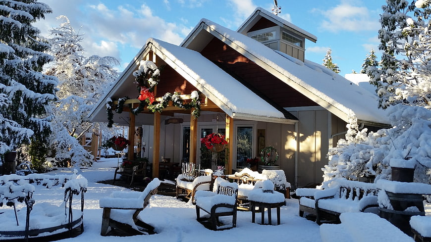Snow-covered house with Christmas decorations in winter