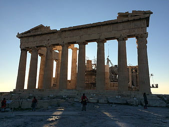 Parthenon at sunset with tourists and scaffolding