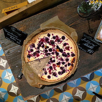 Top view of cherry curd cake on wooden board