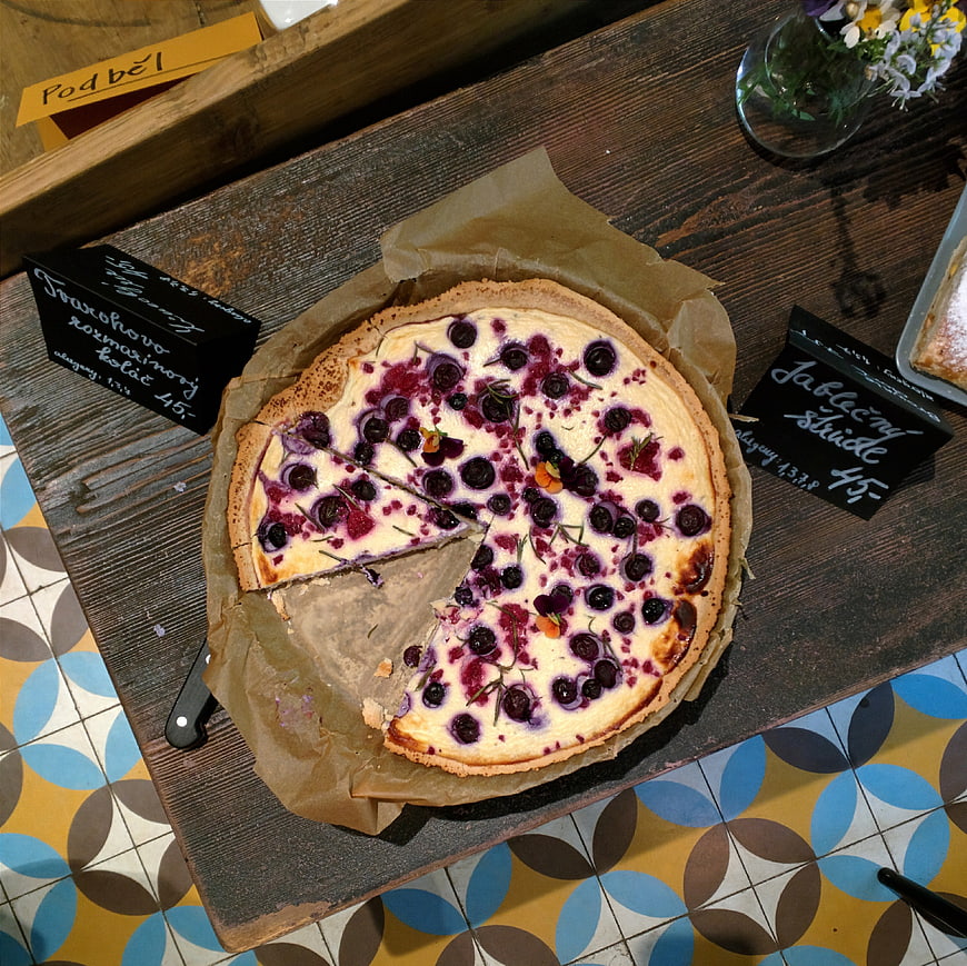 Top view of cherry curd cake on wooden board