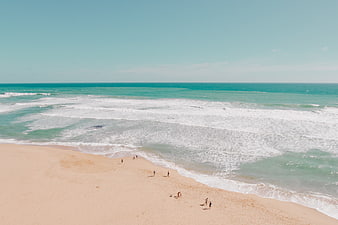 Aerial View of Turquoise Ocean Waves Crashing on Sandy Beach