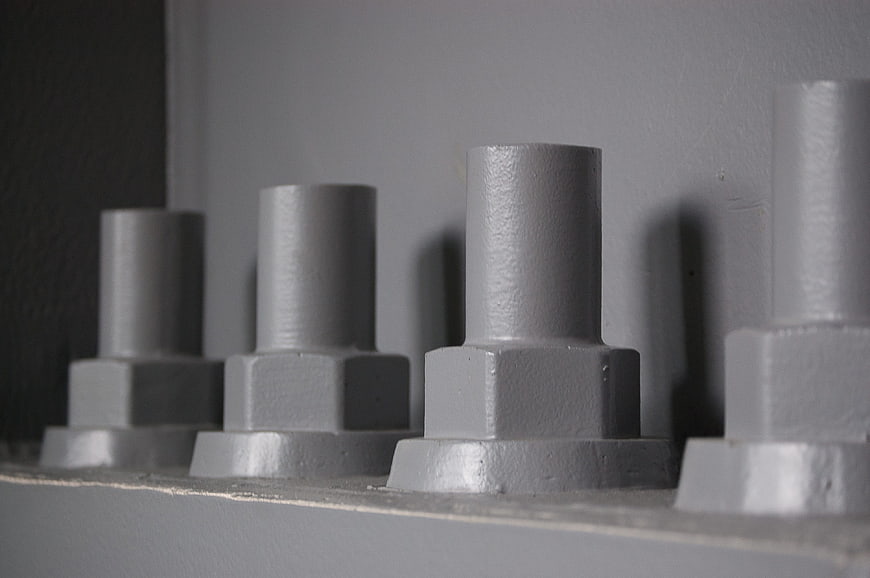Close-up of gray industrial bolts on metal surface