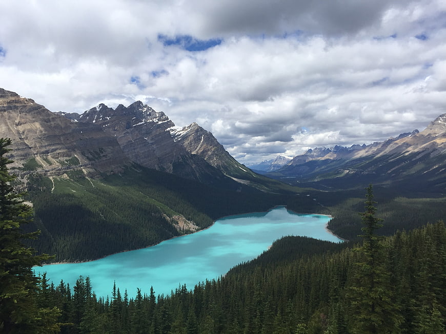 Turquoise Mountain Lake Surrounded by Forest and Peaks