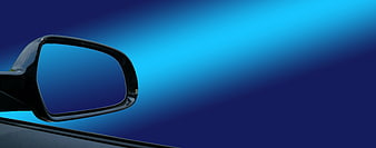 Car Side Mirror Against Blue Gradient Background