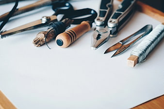 Jewelry Making Tools and Wire on White Paper