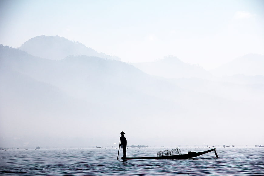 Silhouette of Inle Lake Fisherman Rowing in Foggy Morning