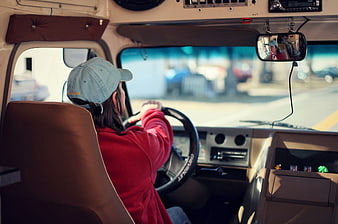 Woman Driving Van Interior With Rearview Mirror Reflection