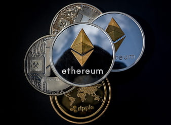 Physical Ethereum, Litecoin, and Ripple cryptocurrency coins on black background