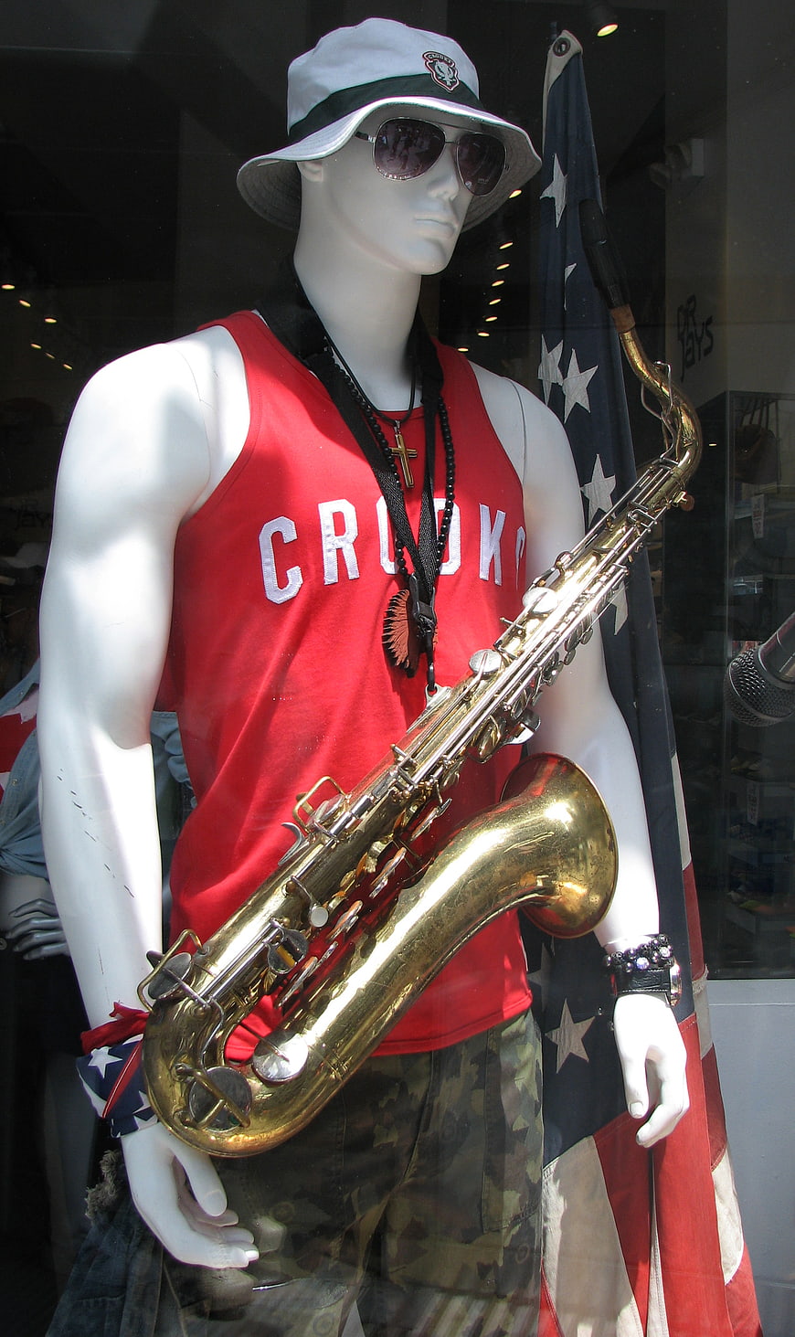 Mannequin with Saxophone and American Flag in Store Window