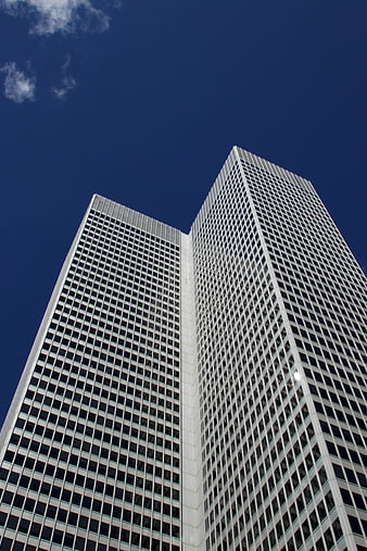 Low angle view of modern skyscrapers against blue sky