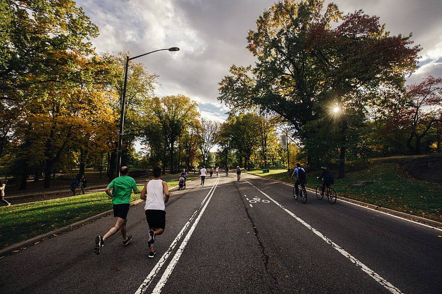 Runners and Cyclists on Park Road in Autumn