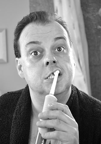 Funny Man Brushing Teeth with Electric Toothbrush