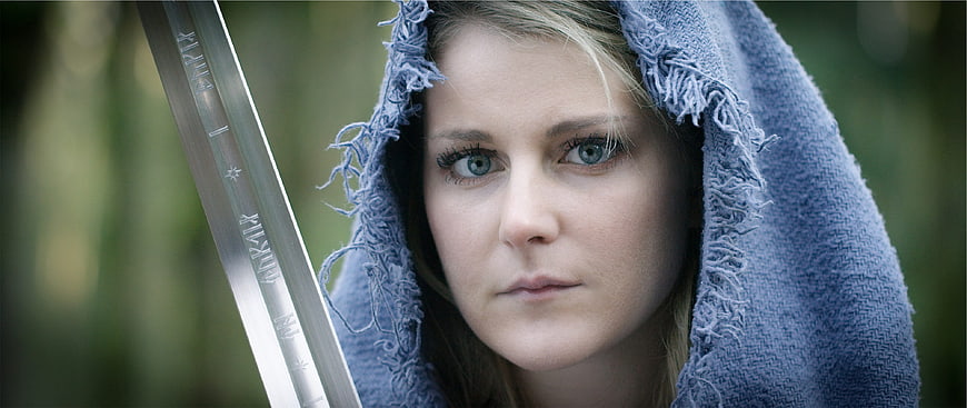 Cinematic Portrait of Woman in Blue Hood with Sword