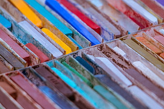 Close-up of colorful pastel chalk sticks in wooden box