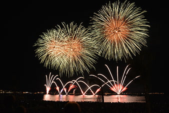 Spectacular Fireworks Display Over Water at Night
