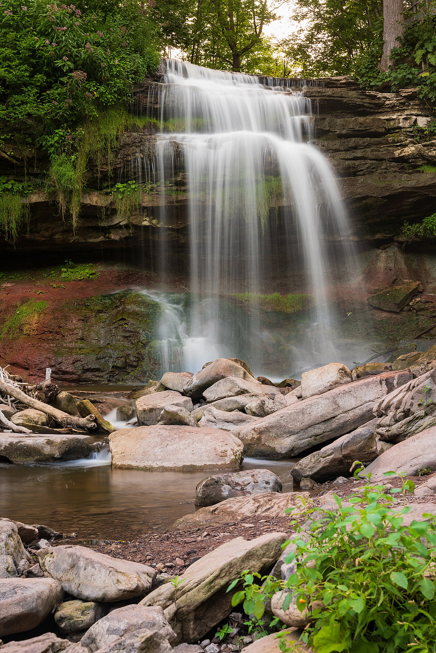 Serene Waterfall Cascading Over Rocks in Lush Forest