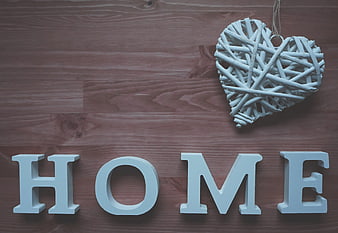 White wooden HOME letters and heart on rustic background