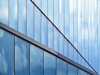 Modern Glass Building Facade with Sky Reflections