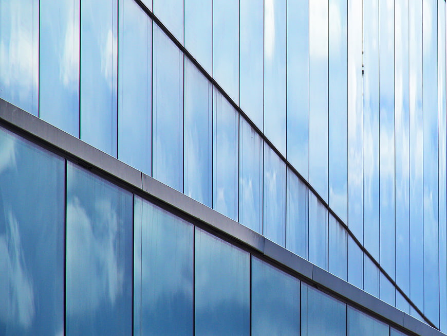 Modern Glass Building Facade with Sky Reflections