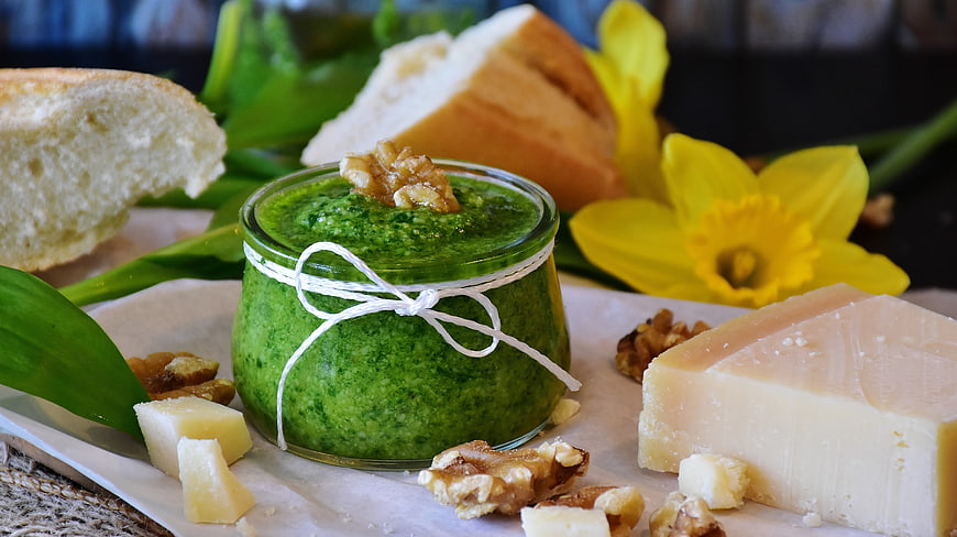 Homemade Wild Garlic Pesto in Glass Jar with Bread and Cheese