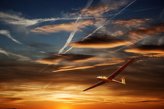 Yellow Glider Soaring in Dramatic Sunset Sky