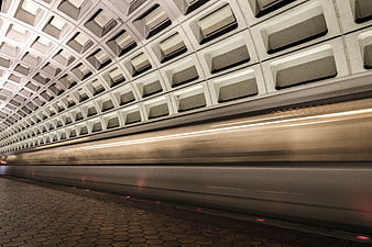 Motion blur subway train in modern concrete tunnel architecture