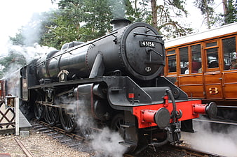 Vintage black steam locomotive 45156 with wooden carriage